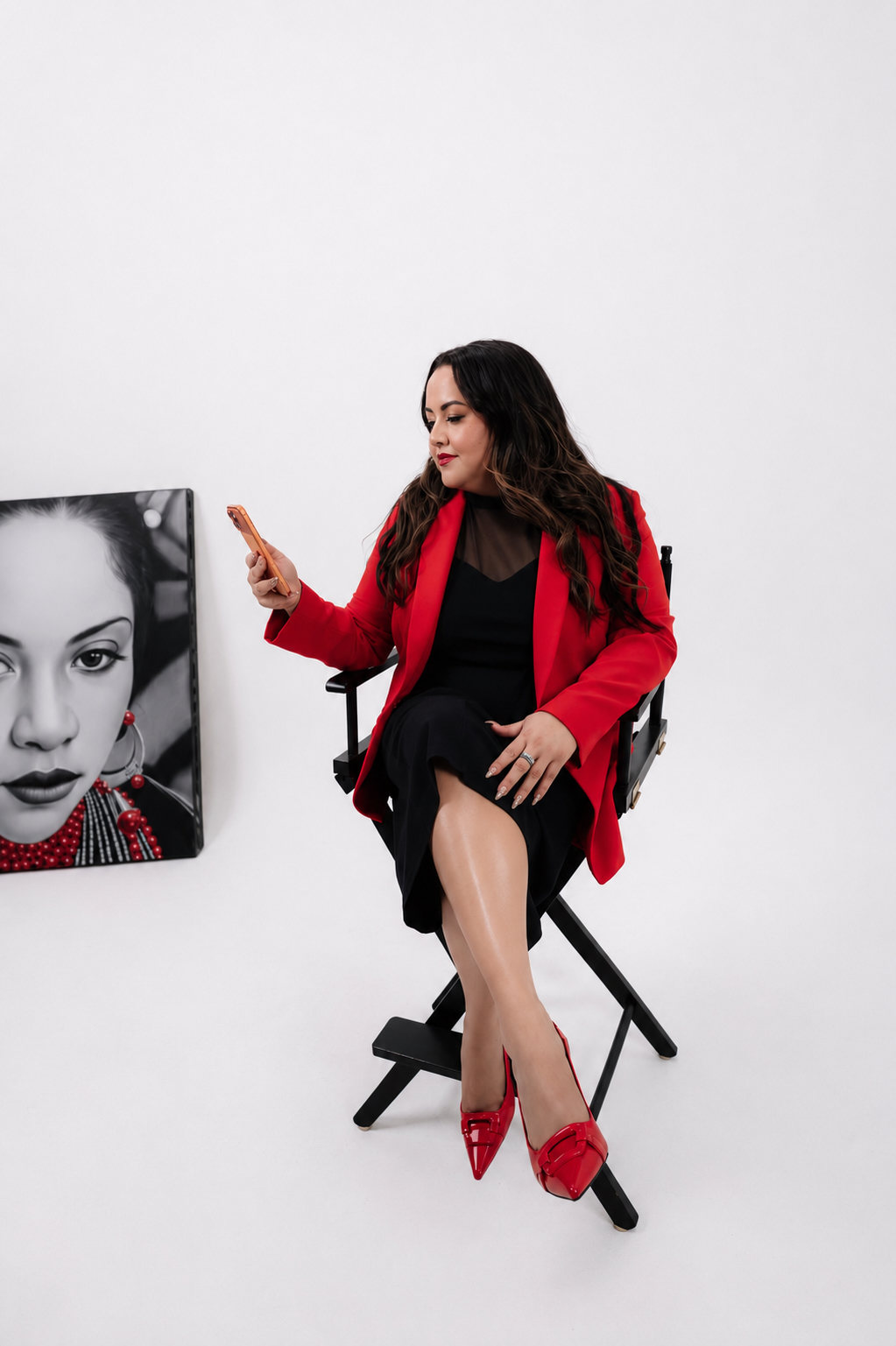 Tania Torres reading on her phone in a director's chair